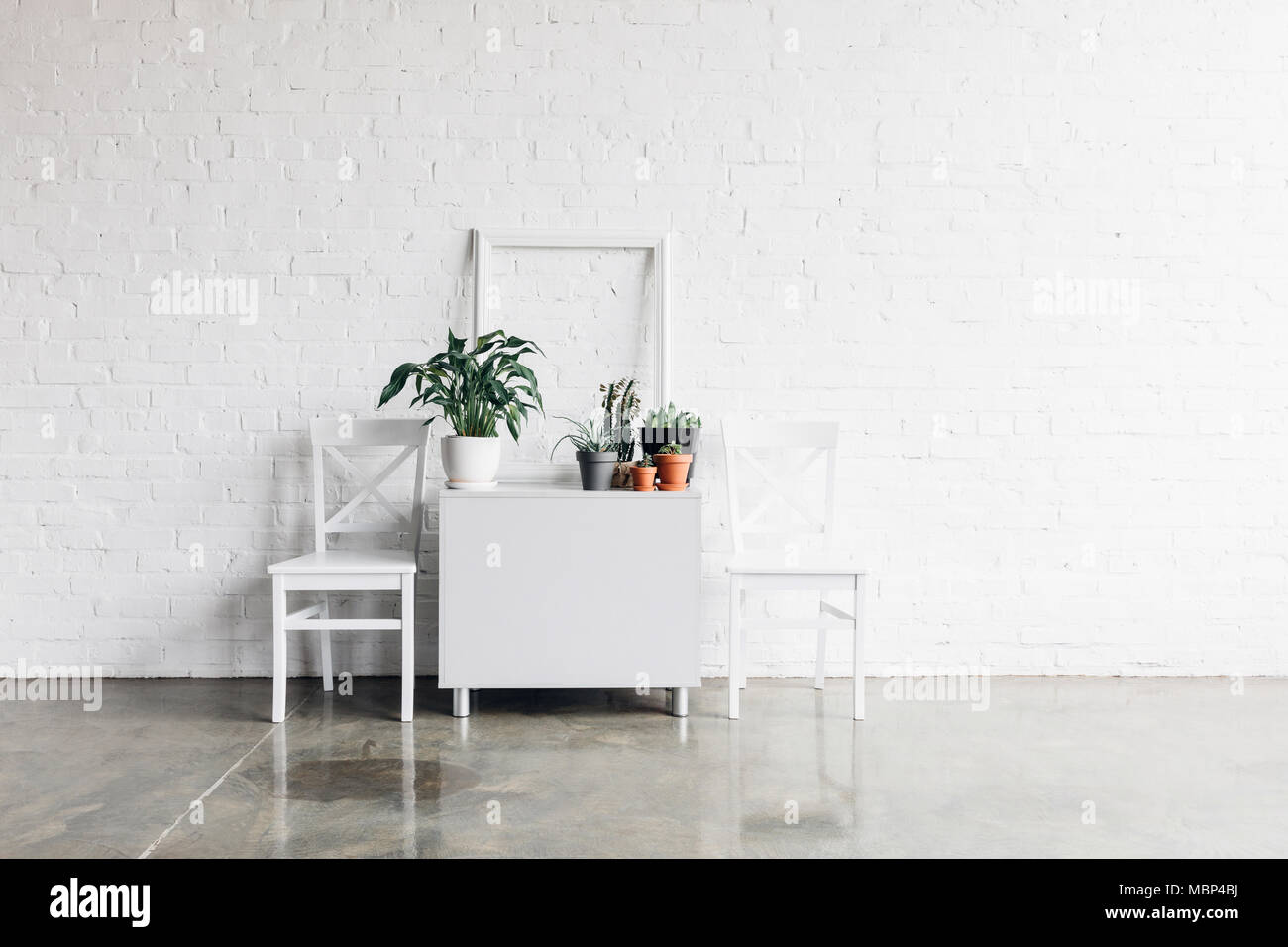 house decor in front of white brick wall, mockup concept Stock Photo