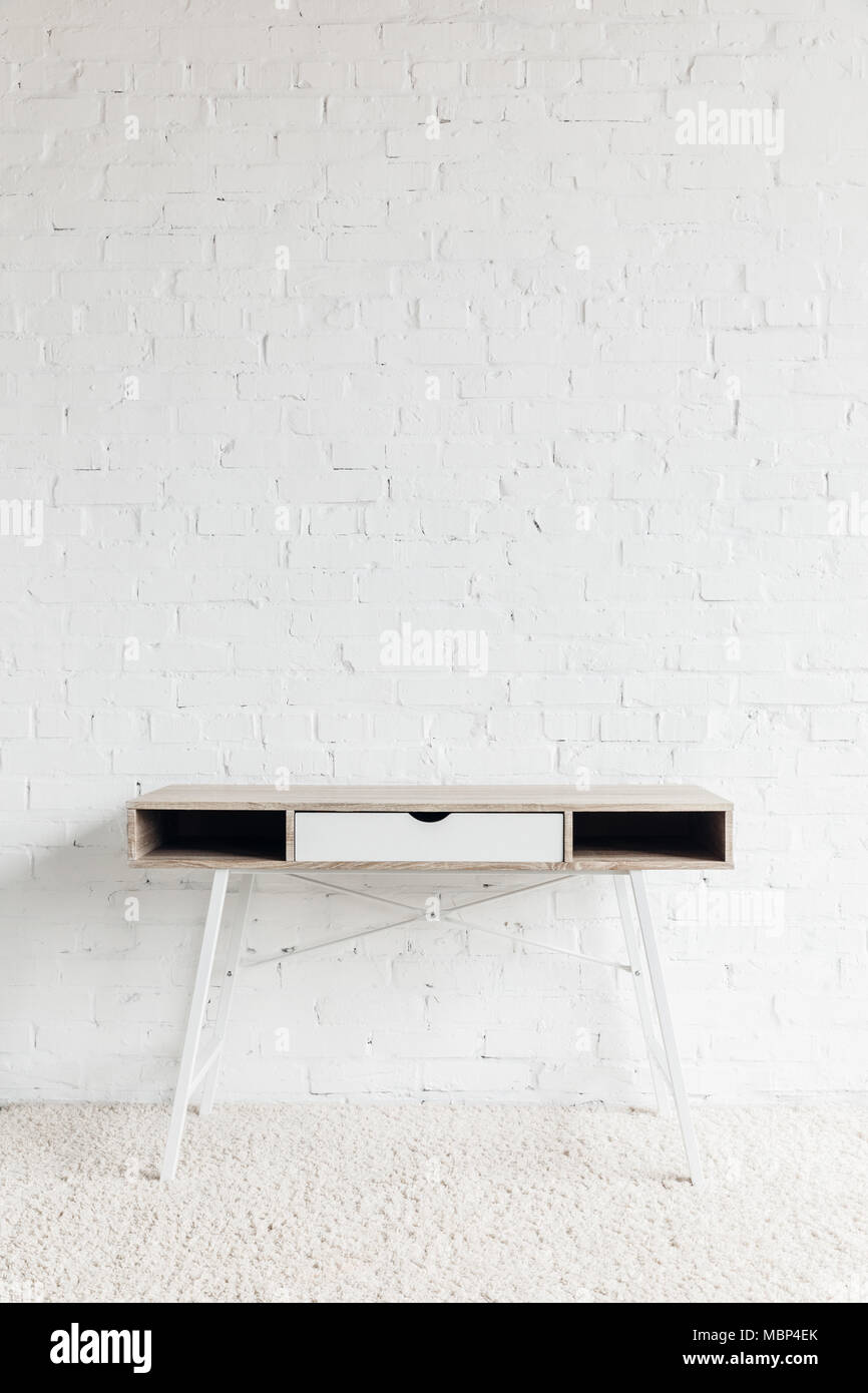 Empty Working Table empty work table in front of white brick wall, mockup concept Stock ...