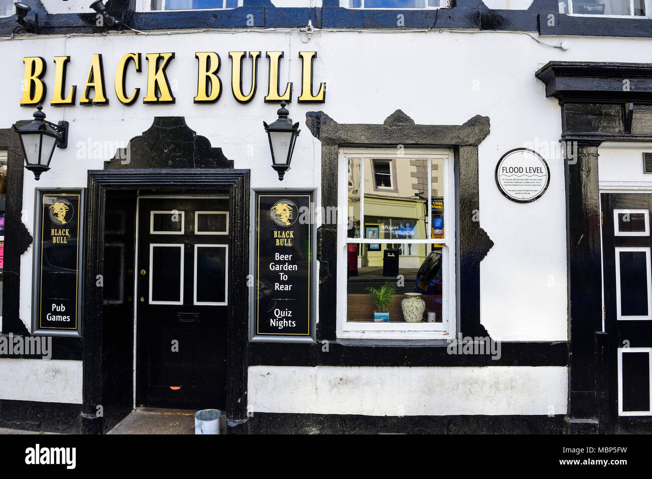 Black Bull public house with wall plaque recording the flood level during the 2009 floods in Cockermouth in the Lake District, Cumbria, England Stock Photo
