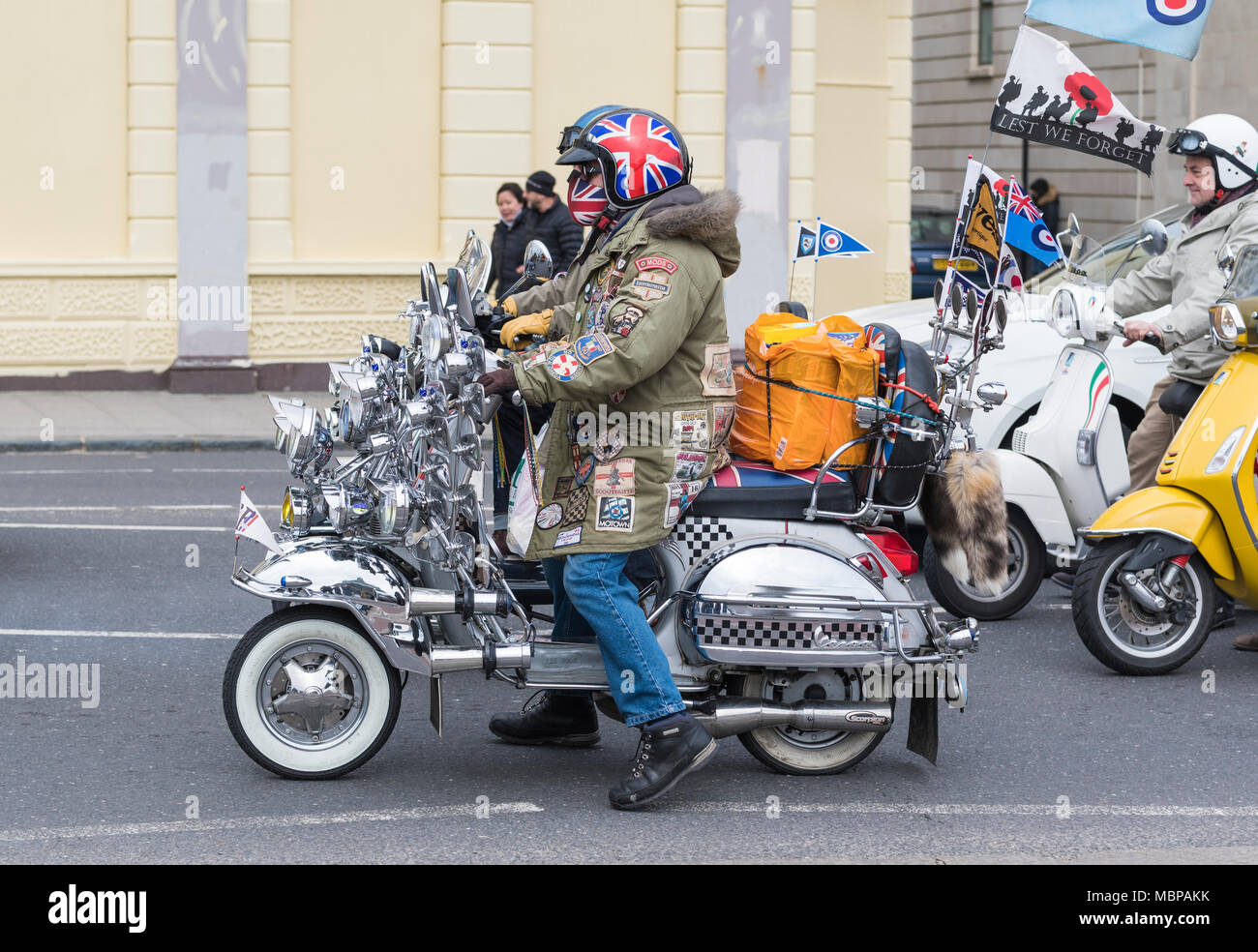 Group of British Mods on decorated motor scooters on a road in Brighton, East Sussex, England, UK. British mods. Stock Photo