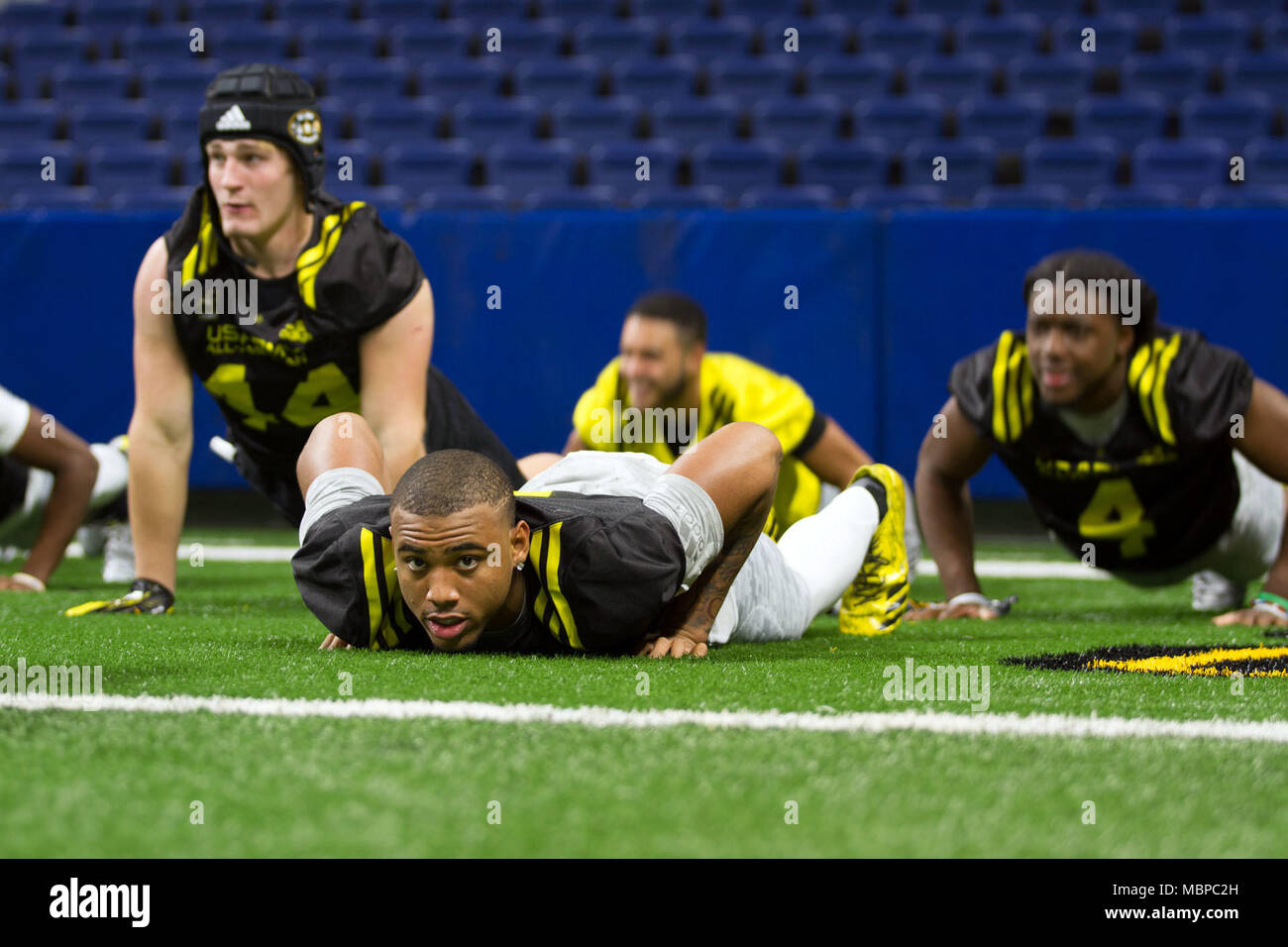 Jaiden Woodbey, a football player from St. John Bosco High School in Fontana, Calif., and the rest of the U.S. Army All-Americans participate in an Army physical training session with members of the U.S. Army prior to playing a friendly 7-on-7 football game in the Alamodome in the week leading up to the U.S. Army All-American Bowl, Jan. 2, 2017 in San Antonio, Texas. During Bowl week, players and band members are paired with Army Soldier Mentors, outstanding Soldiers who have earned distinctions from their commands. The Soldier Mentors attend practices and events throughout the week, which off Stock Photo