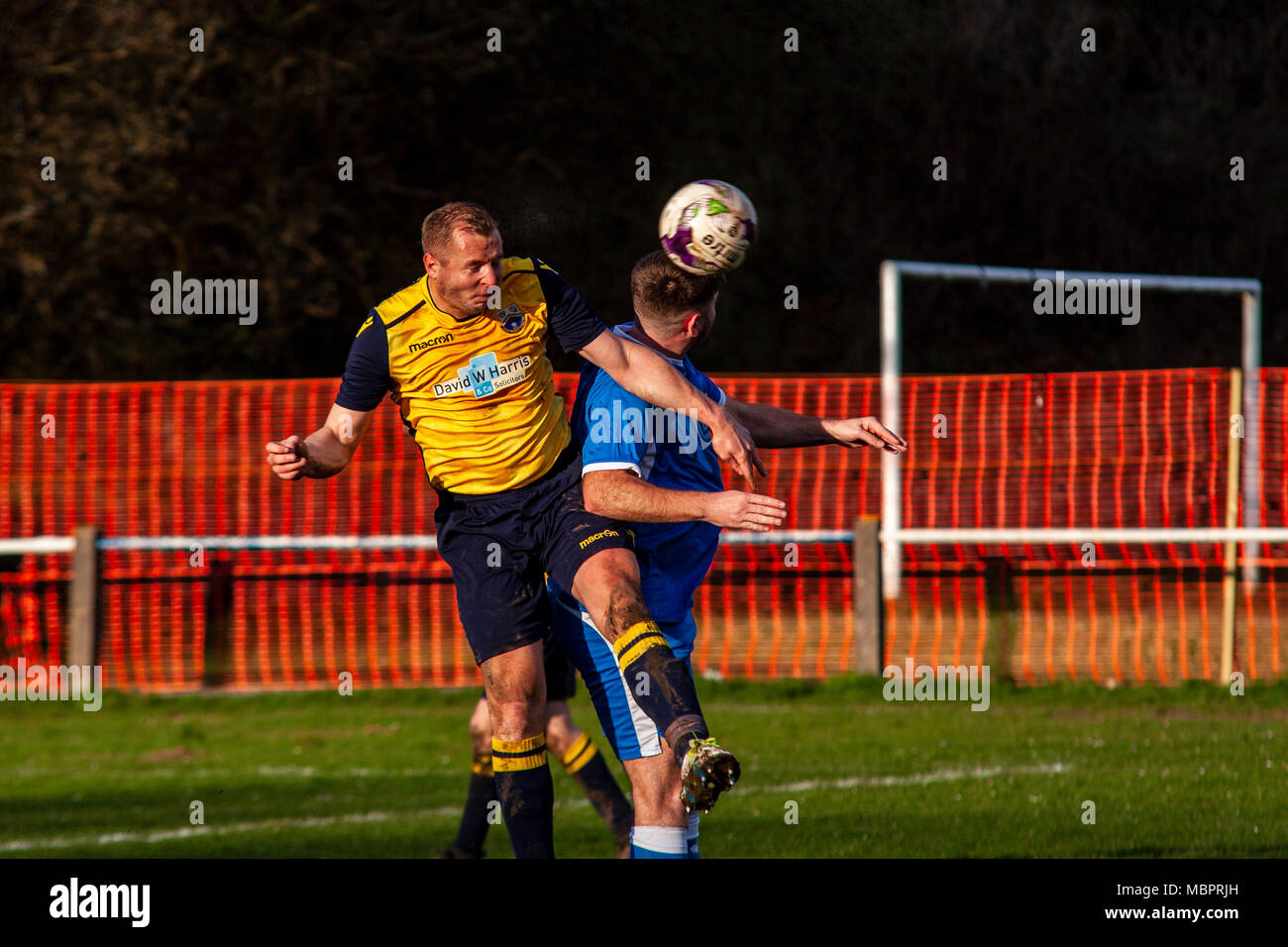 Port Talbot Town defender Rhys Owen clears the ball with a header, Cwmamman United 2-2 Port Talbot Town. Stock Photo