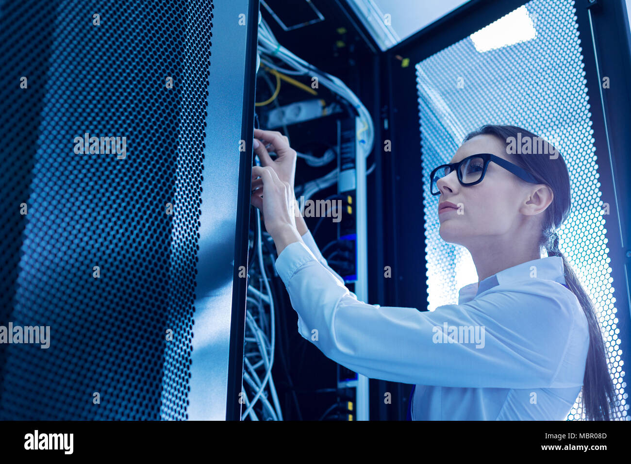 Professional operator fixing important wires Stock Photo - Alamy