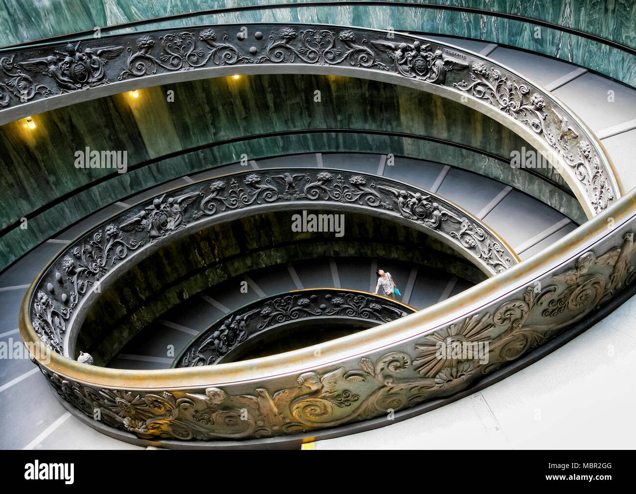 Rome, Italy - June 20, 2011: Tourist amused on spiral staircase in the Vatican Museum Stock Photo