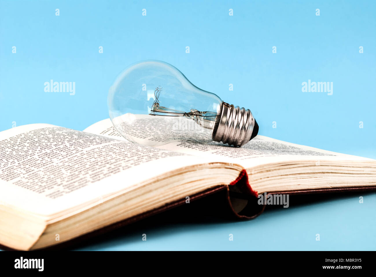 Bulb on an open old book close-up Stock Photo