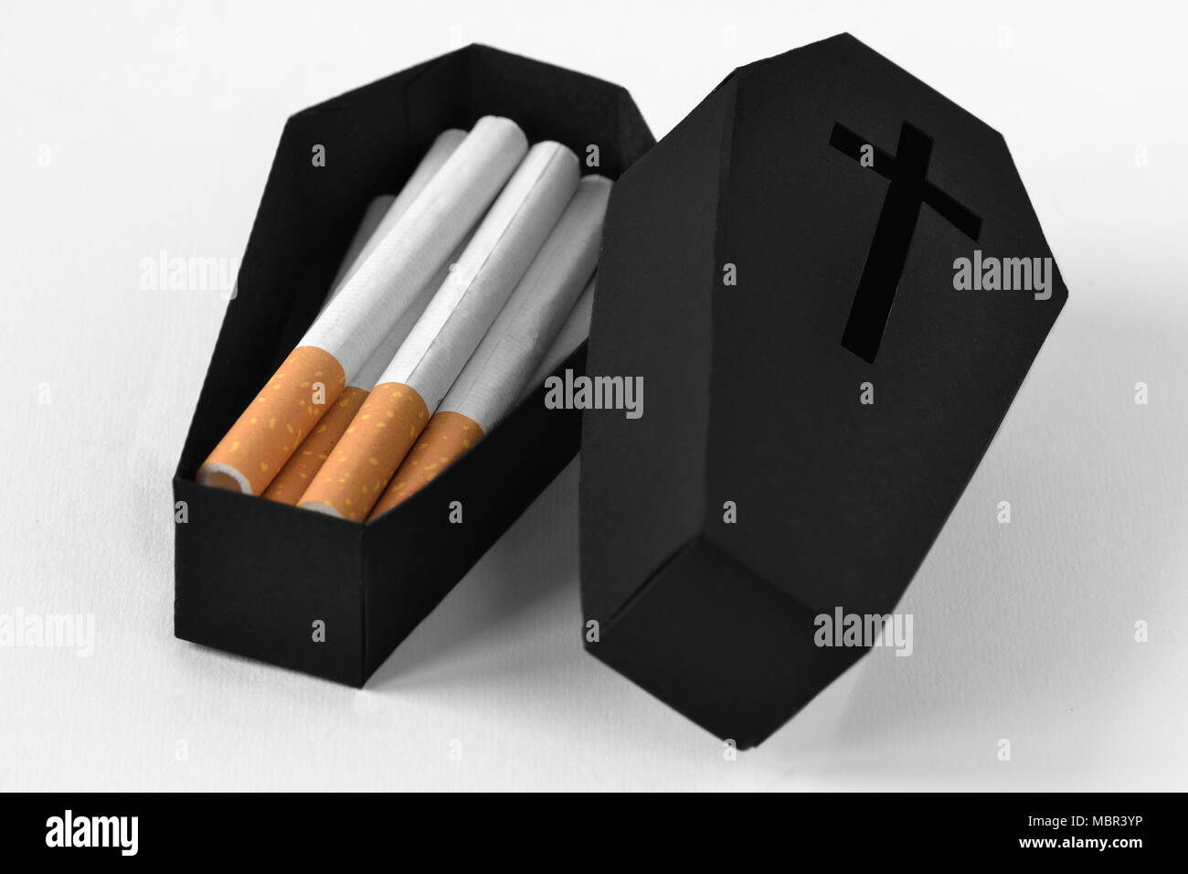 Cigarettes in a black coffin on white background - Stop smoking concept  Stock Photo