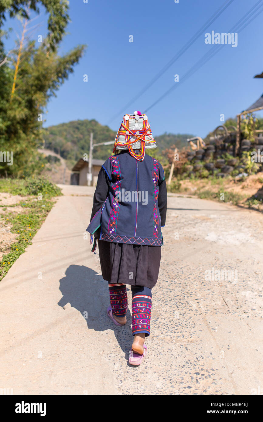 Chiang Rai, Thailand - February 8, 2017: Unidentified Akha woman with traditional clothes and decorated hat in Akha hilltribe village in Northern Thai Stock Photo