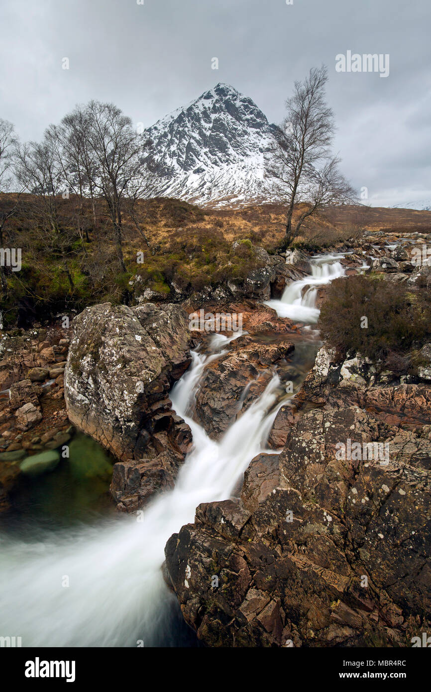 Scottish mountain Buachaille Etive Mòr and waterfall on River Coupall in winter in Glen Etive near Glencoe in the Highlands of Scotland, UK Stock Photo