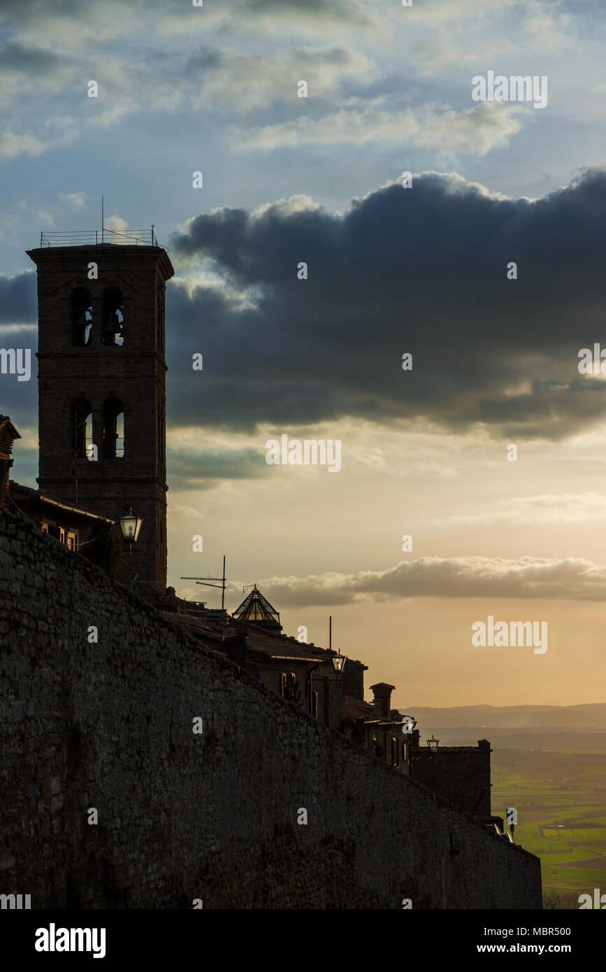 View of the medieval town of Cortona with Val di Chiana Valley in Tuscany at sunset Stock Photo