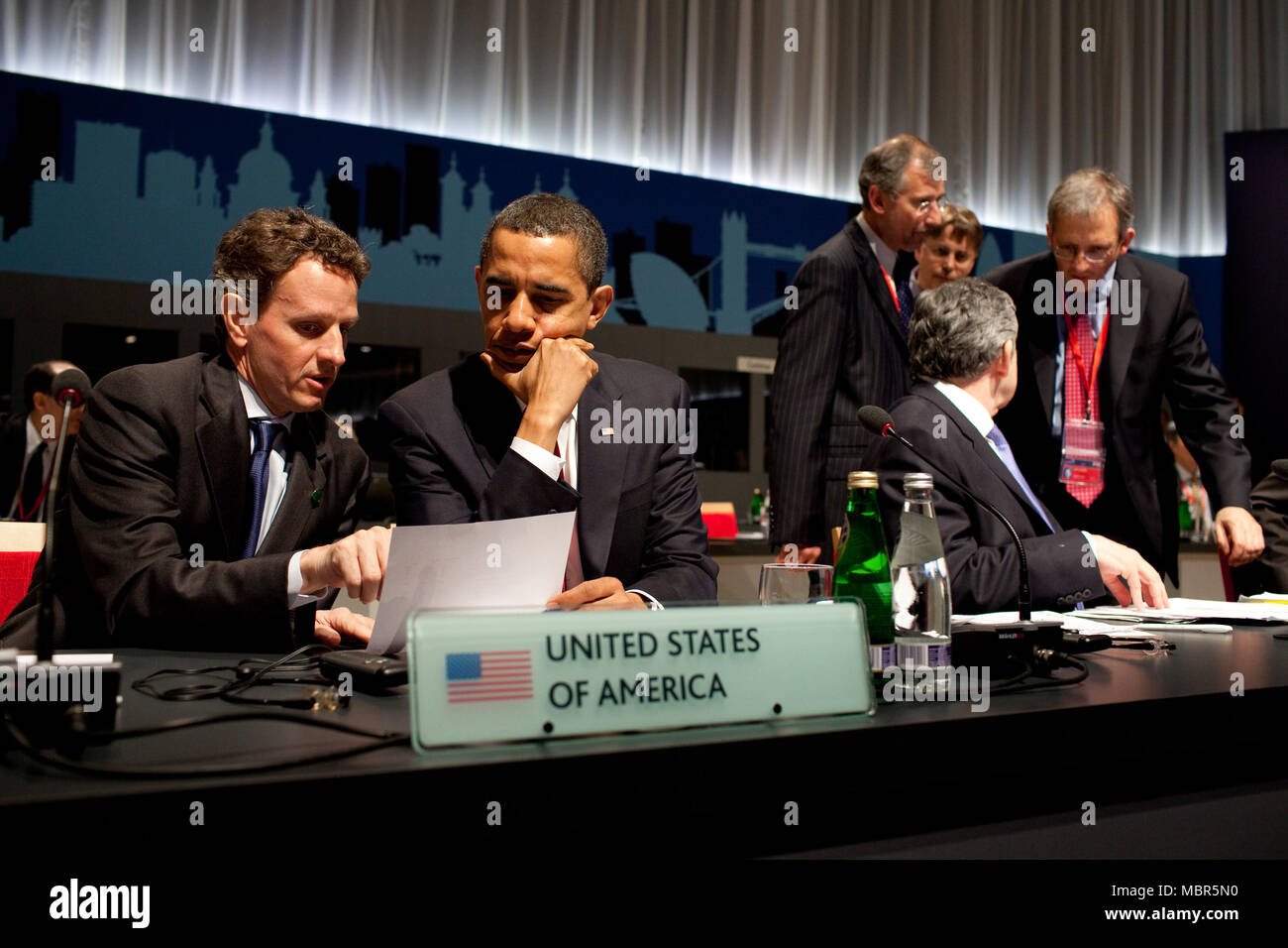 President Barack Obama confers with U.S. Treasury Secretary Timothy Geithner during the G-20 Summit  April 2, 2009, at the ExCel Centre in London. Official White House Photo by Pete Souza Stock Photo