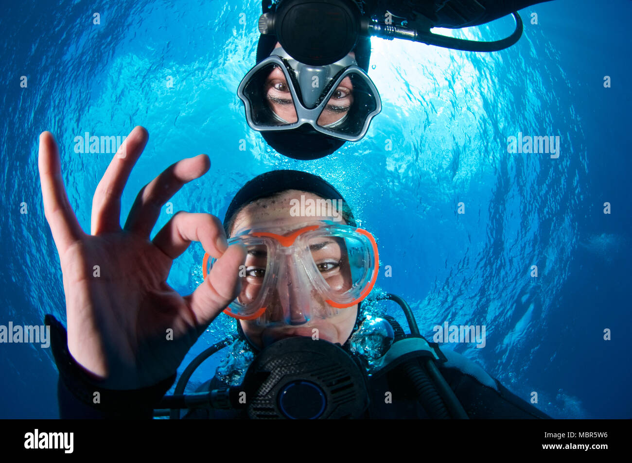 Scuba divers selfie making OK signal with Snell’s window in the background in Mar de las Calmas Marine Reserve (El Hierro, Canary Islands, Spain) Stock Photo