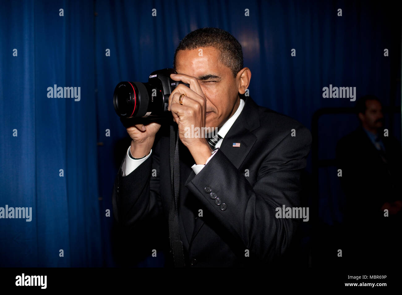 President Barack Obama takes aim with a photographer's camera backstage prior to remarks about providing mortgage payment relief for responsible homeowners. Dobson High School. Mesa, Arizona 2/18/09. .Official White House Photo by Pete Souza Stock Photo