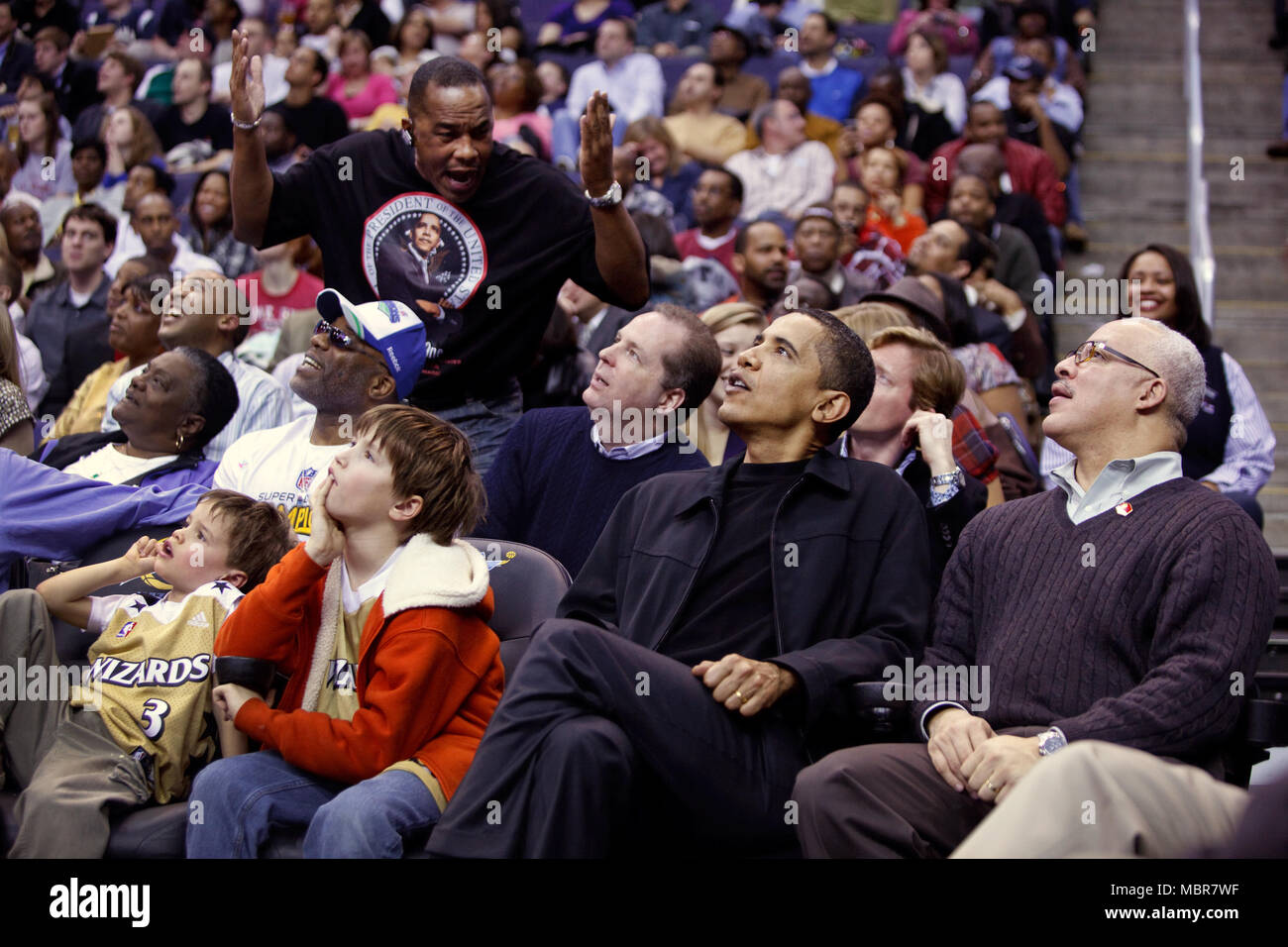 President Barack Obama attends a Washington Wizards vs Chicago Bulls basketball game at the Verizon Center, Washington, D.C 2/27/09.  Official White House Photo by Pete Souza Stock Photo