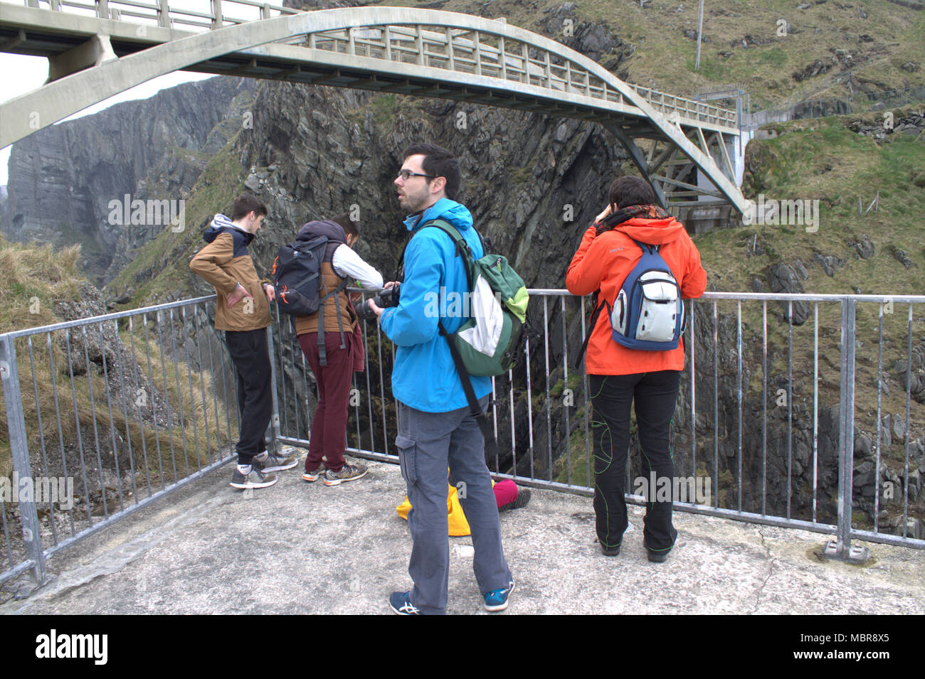 visitors on a viewing point looking into the mizen head gorge and up to the mizen head footbridge, taking photographs of the fantastic view. Stock Photo