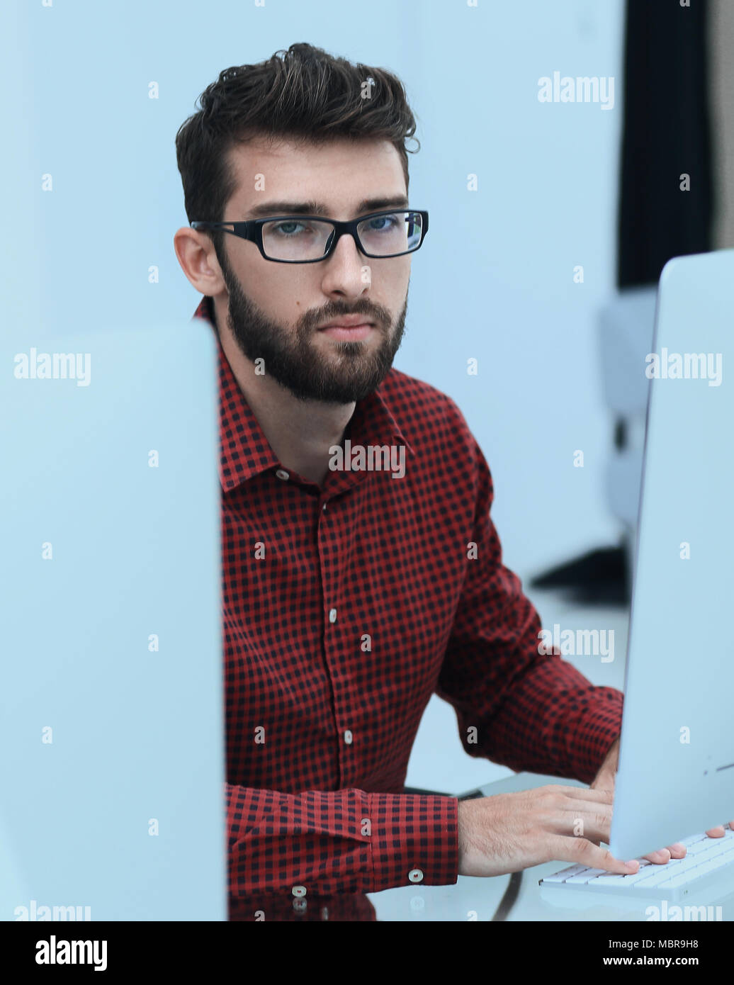 employee sitting in front of a computer monitor Stock Photo Alamy