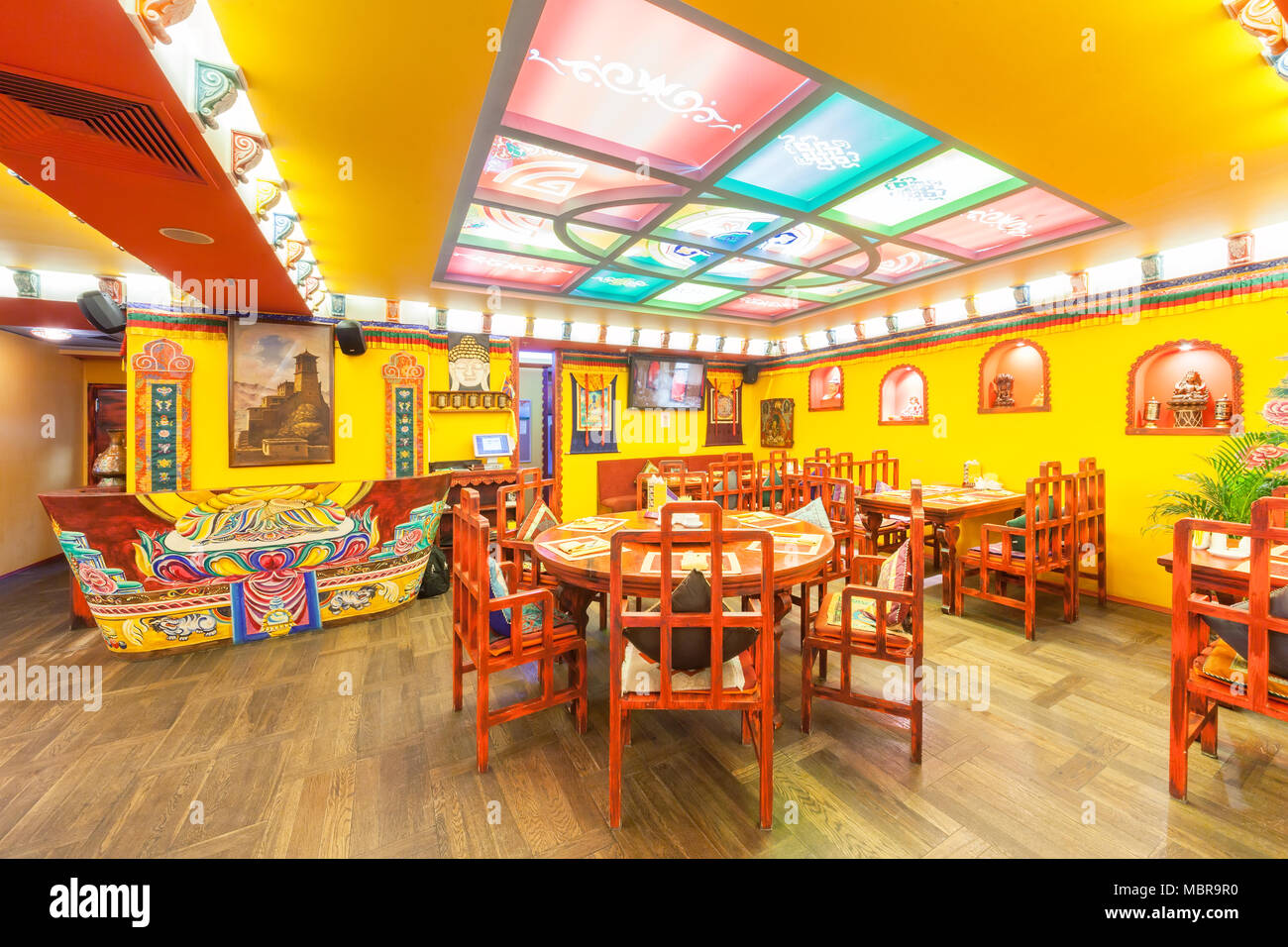 MOSCOW - AUGUST 2014: The interior of the restaurant Indian and Tibetan  cuisine and is decorated in ethnic style. The restaurant room with wooden  furn Stock Photo - Alamy