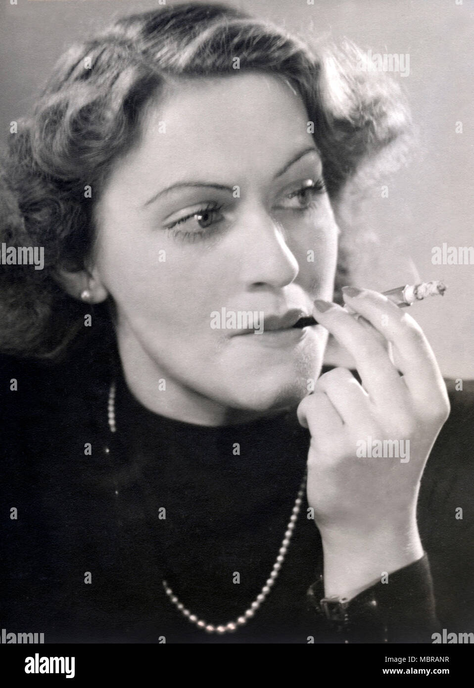 1940's cigarette holder Portrait of a smoking woman with cigarette holder, 1940s, Germany Stock  Photo