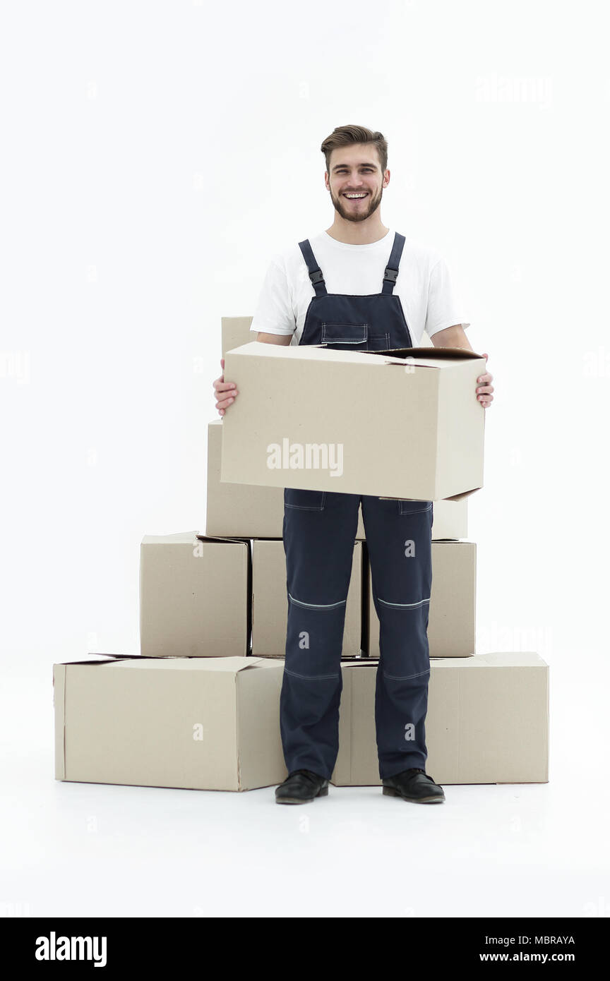 Young man carrying a box to the pile of boxes Stock Photo - Alamy