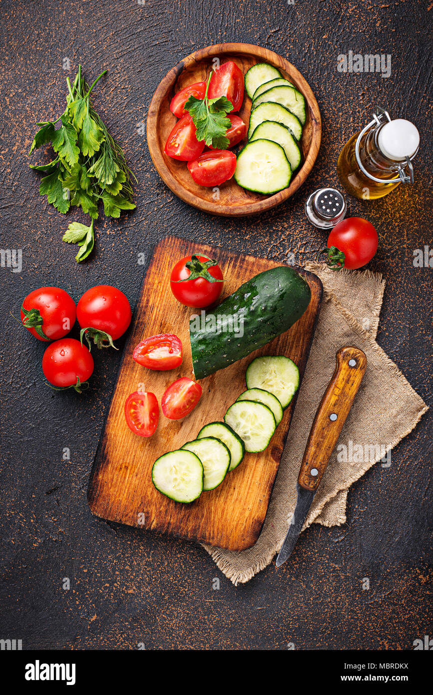 Sliced tomato and cucumber on cutting board Stock Photo - Alamy