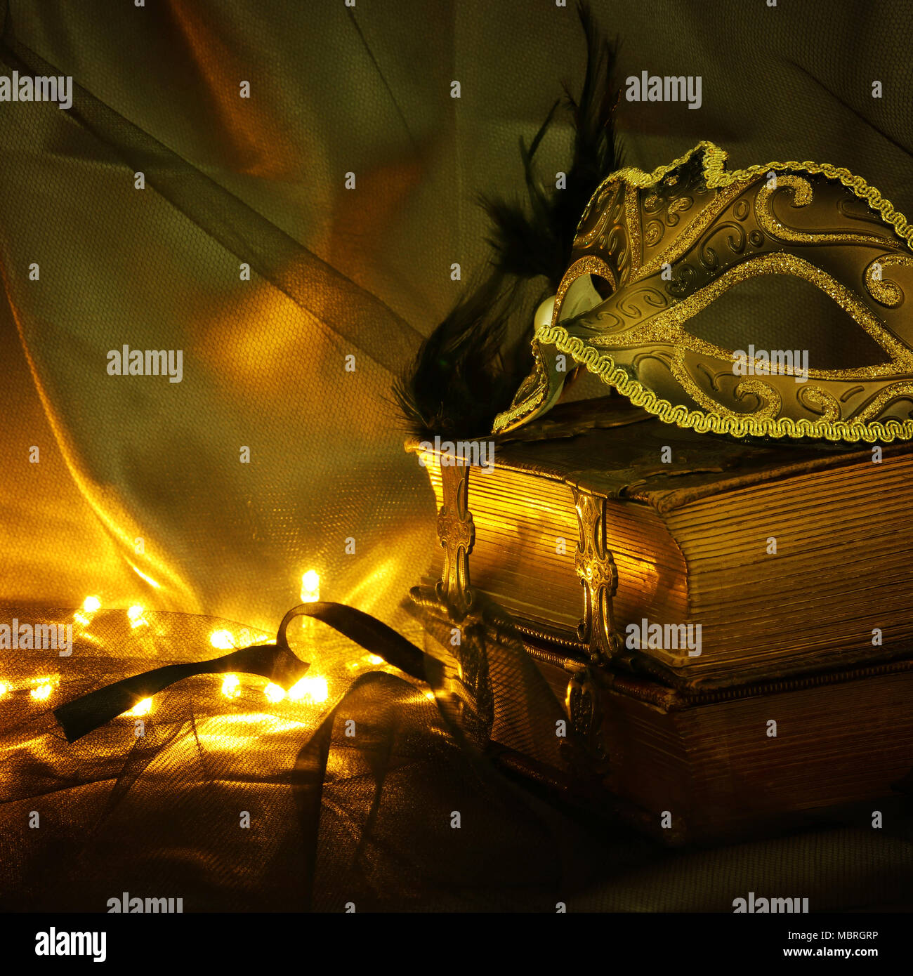 Image of elegant gold and black venetian mask over tulle background ...