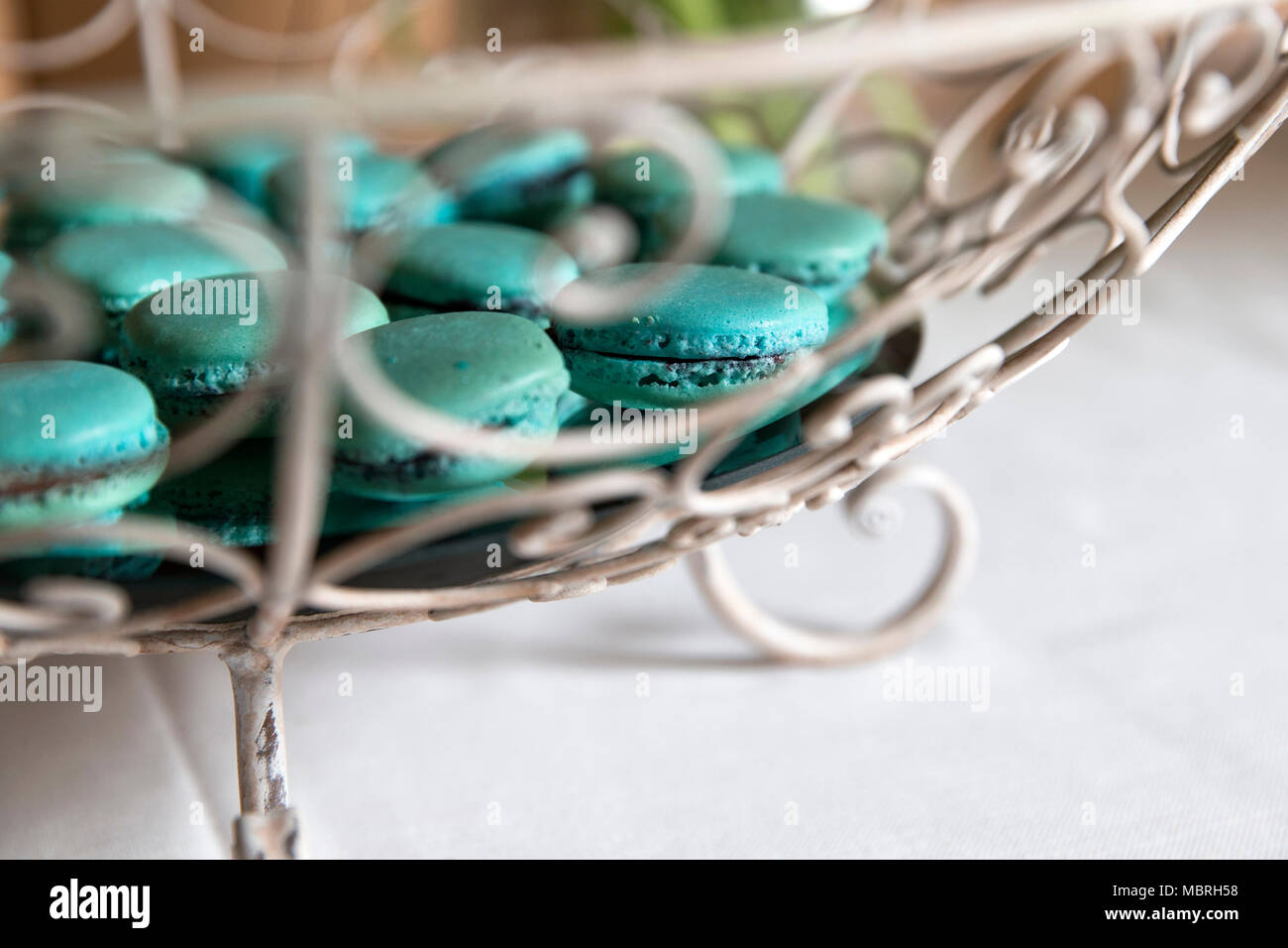 closeup of a vintage metal riser with tiffany green macarones in it. Stock Photo