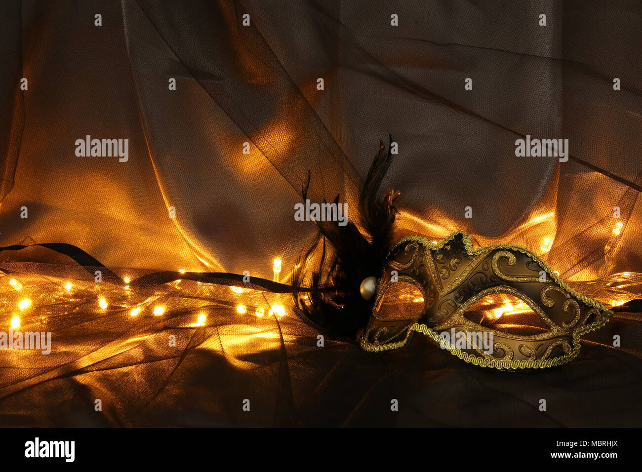 Image of elegant gold and black venetian mask over tulle background ...