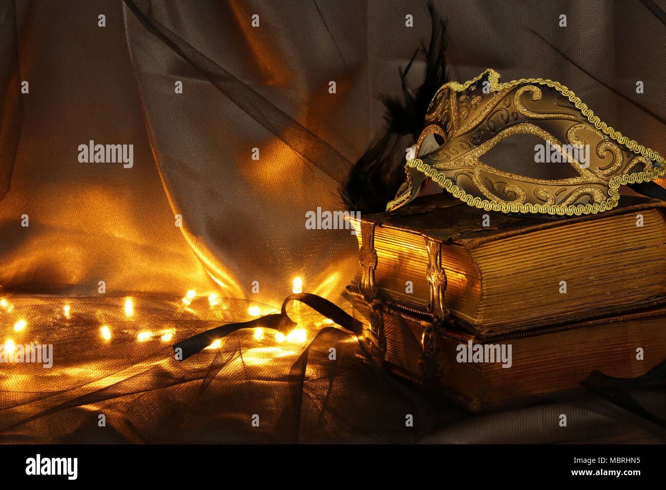 Image of elegant gold and black venetian mask over tulle background ...