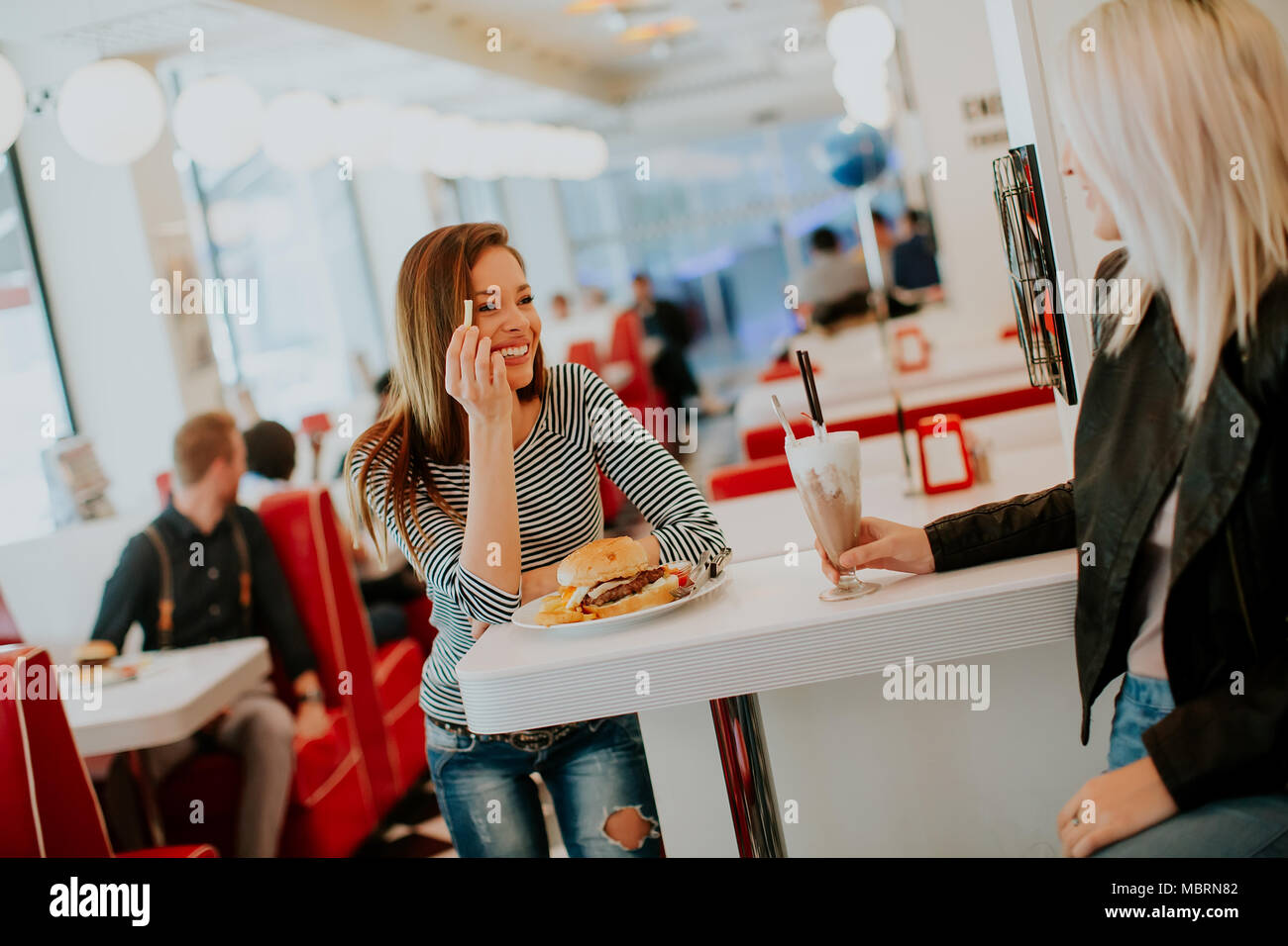 Two young women eating hi-res stock photography and images - Alamy