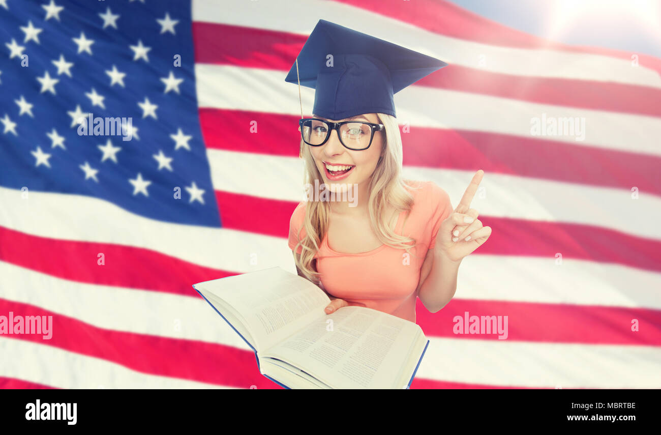 student woman in mortarboard with encyclopedia Stock Photo