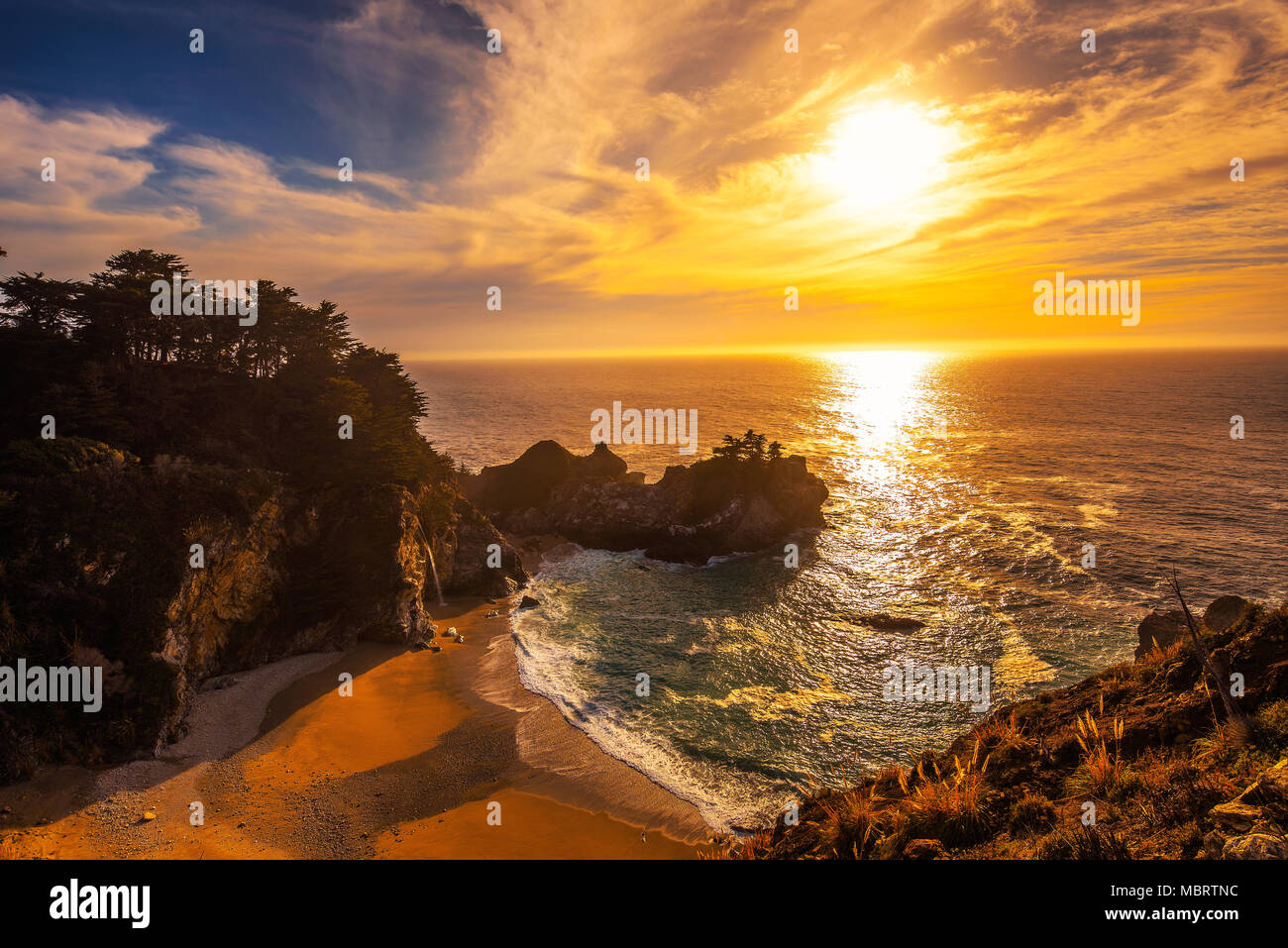 Sunset over McWay Falls on Pacific Coast Highway in California Stock Photo