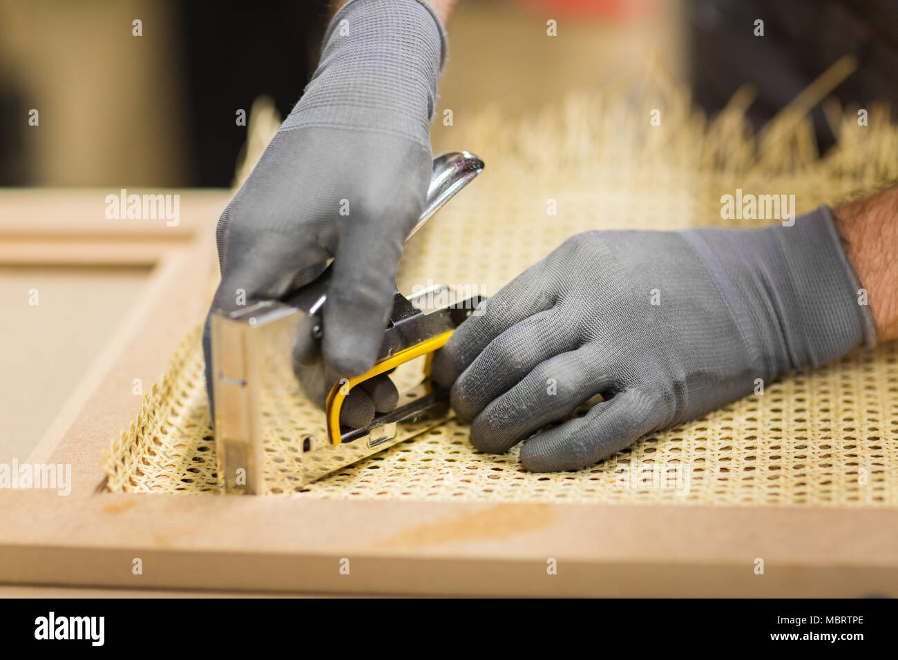 assembler with staple gun making furniture Stock Photo Alamy