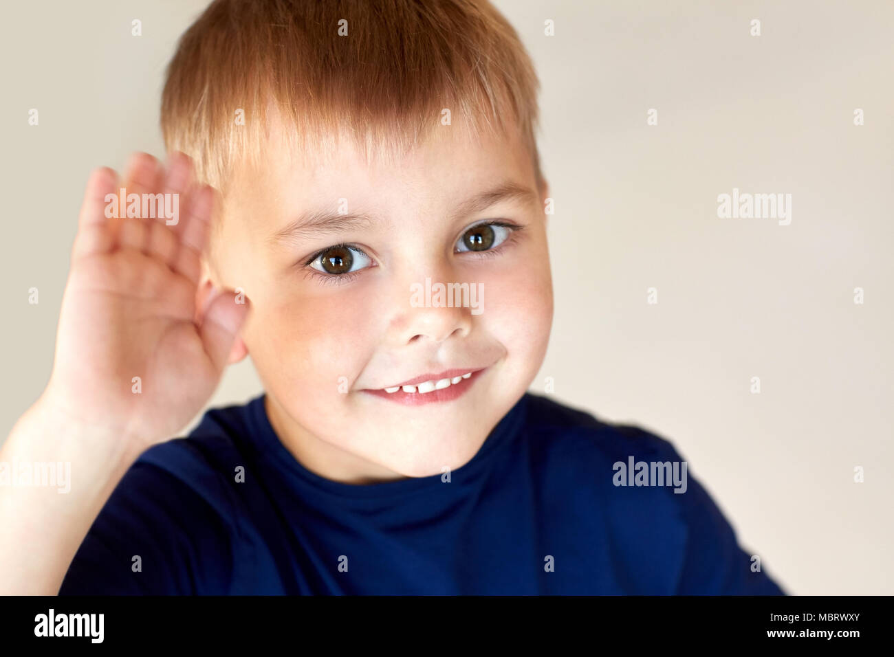 portrait of happy smiling little boy waving hand Stock Photo