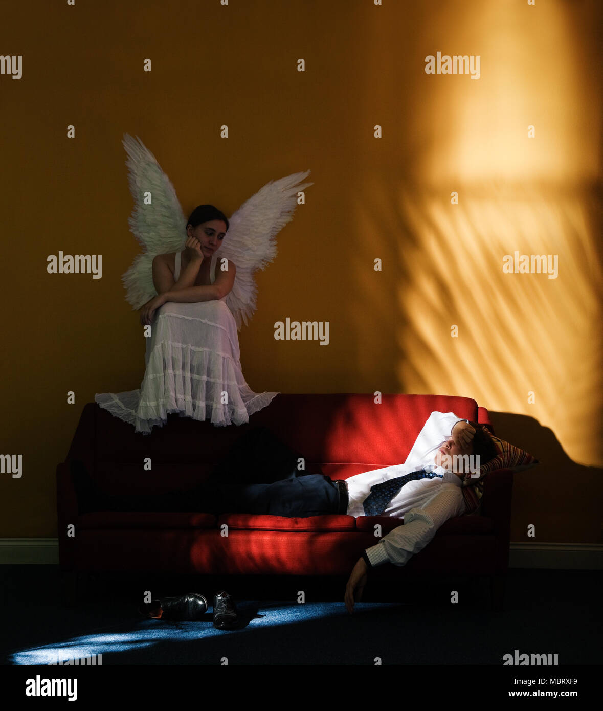Guardian angel looking down on man sleeping Stock Photo Alamy