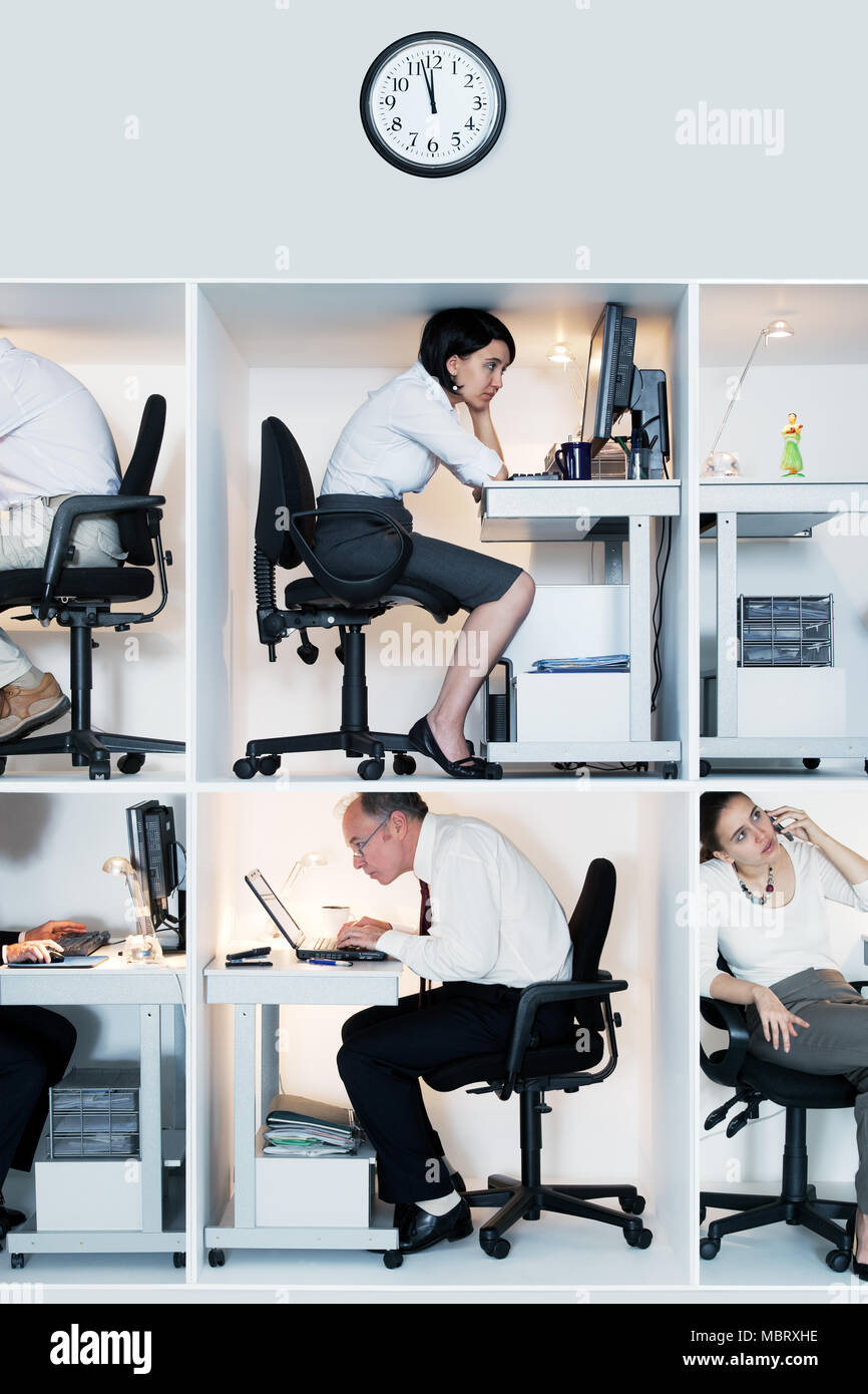 Office workers in tiny cubicles Stock Photo
