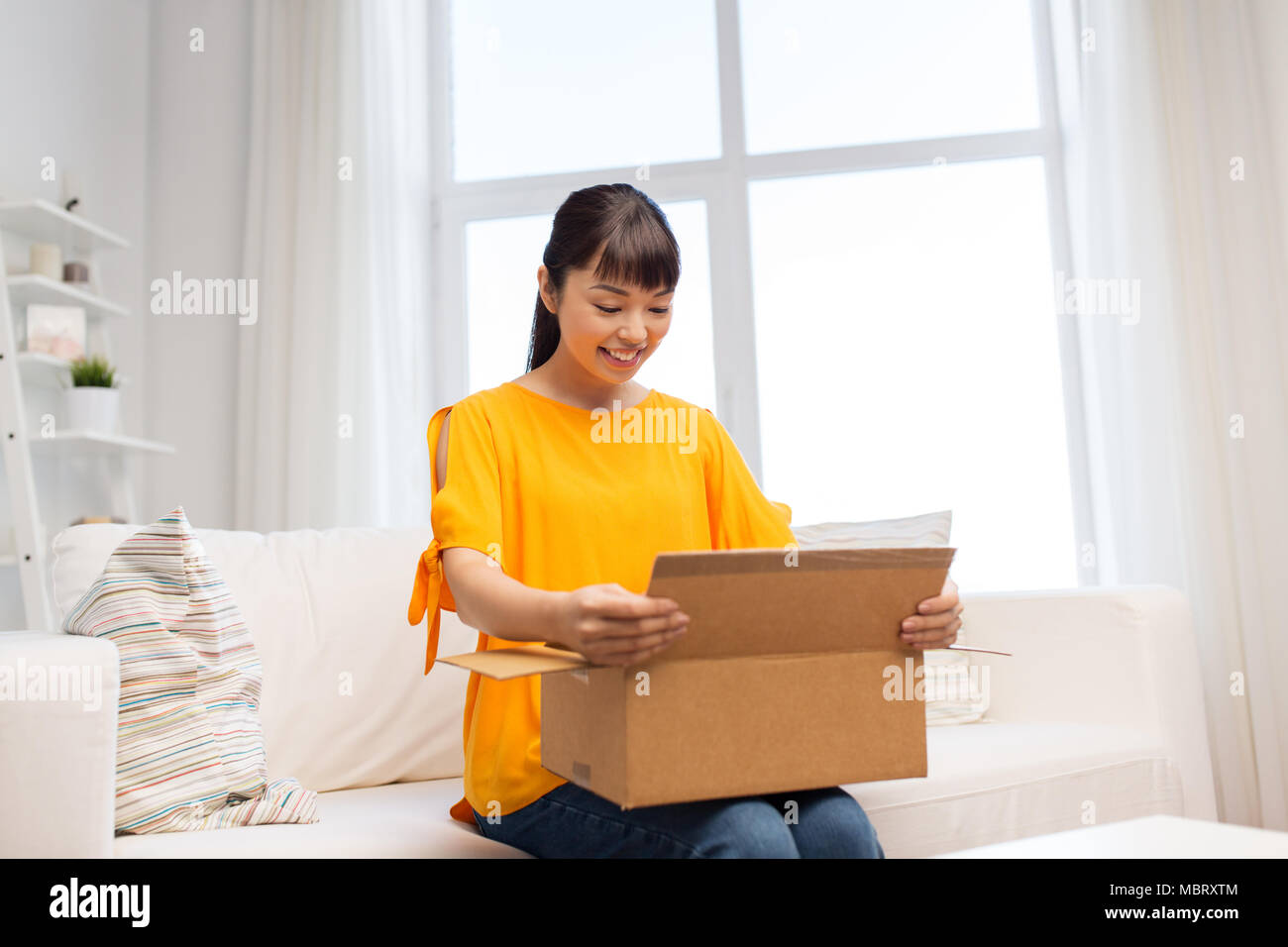 happy asian young woman with parcel box at home Stock Photo - Alamy