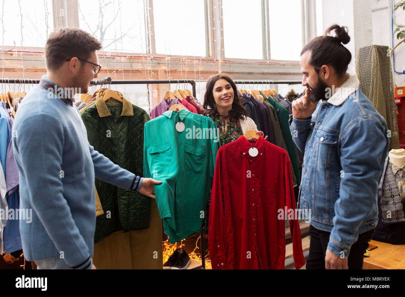 friends choosing clothes at vintage clothing store Stock Photo