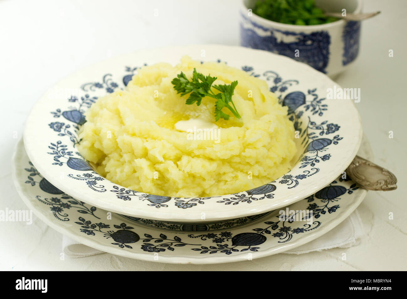 Appetizing mashed potatoes with butter and parsley. Rustic style. Stock Photo