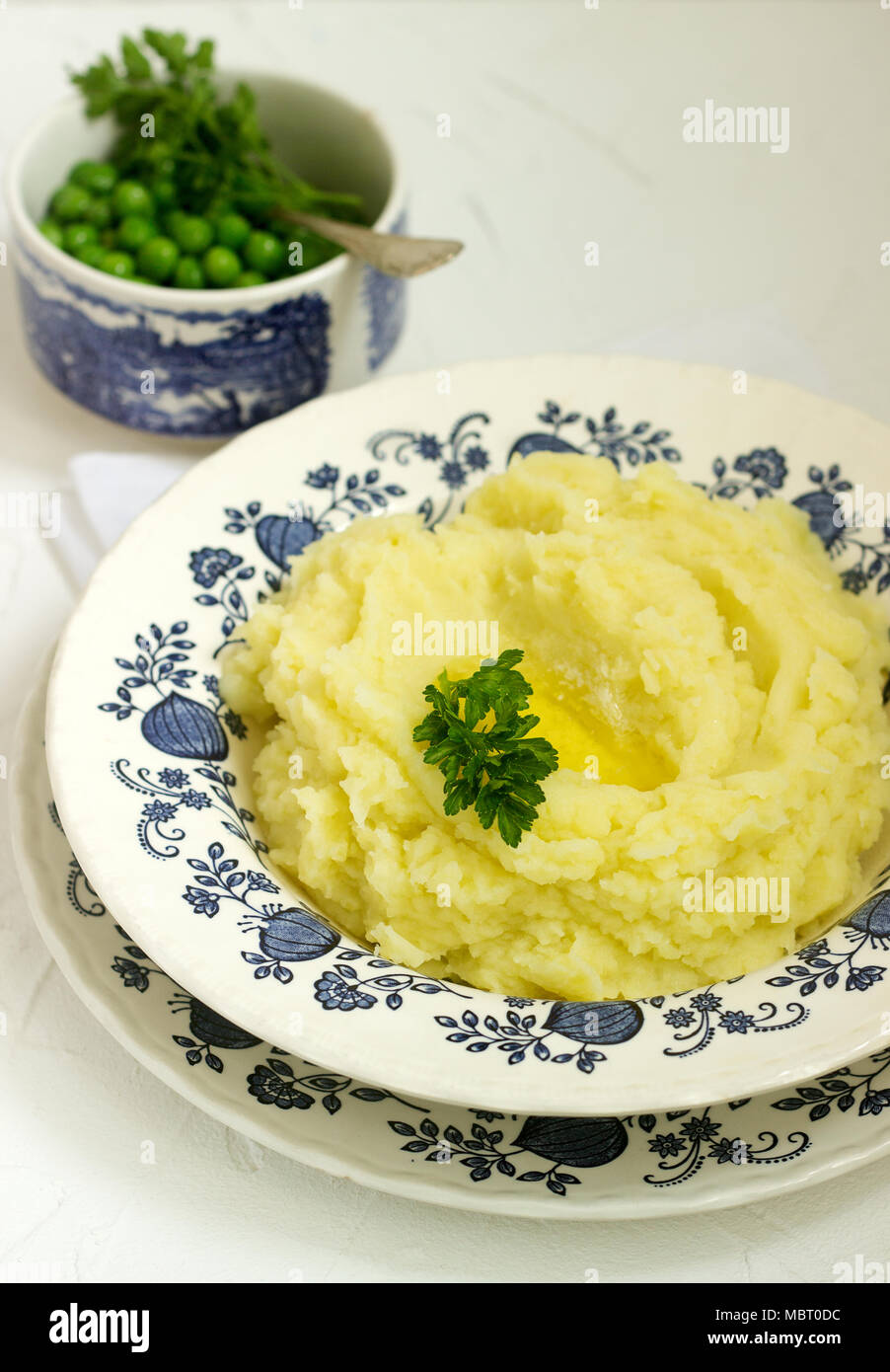 Appetizing mashed potatoes with butter and parsley. Rustic style. Stock Photo