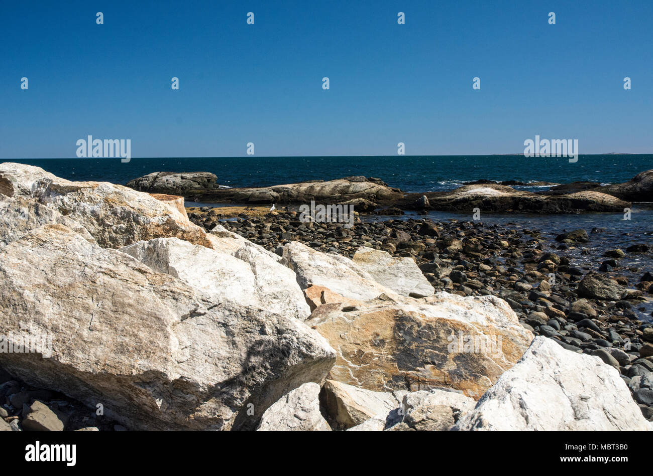Rocks and beach stones create a pretty scenic view Stock Photo - Alamy