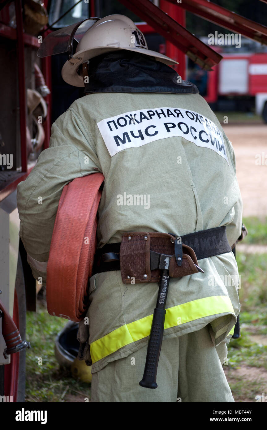 The fireman pulls out the fire hose from the car Stock Photo Alamy