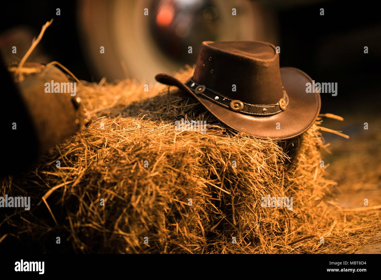 Leather Cowboy Hat on the Small Pile of Hay in the Old Barn. Western Wear  and Wild West Concept Stock Photo - Alamy
