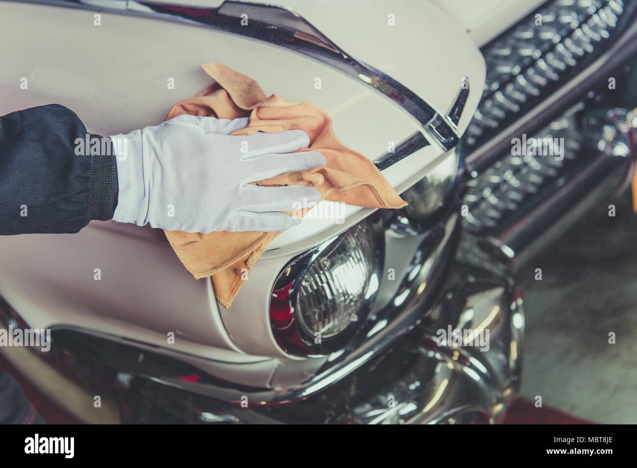 Taking Care of Classic Car. Passionate Vintage Cars Collector Cleaning One of His Vehicle. Closeup Photo. Stock Photo