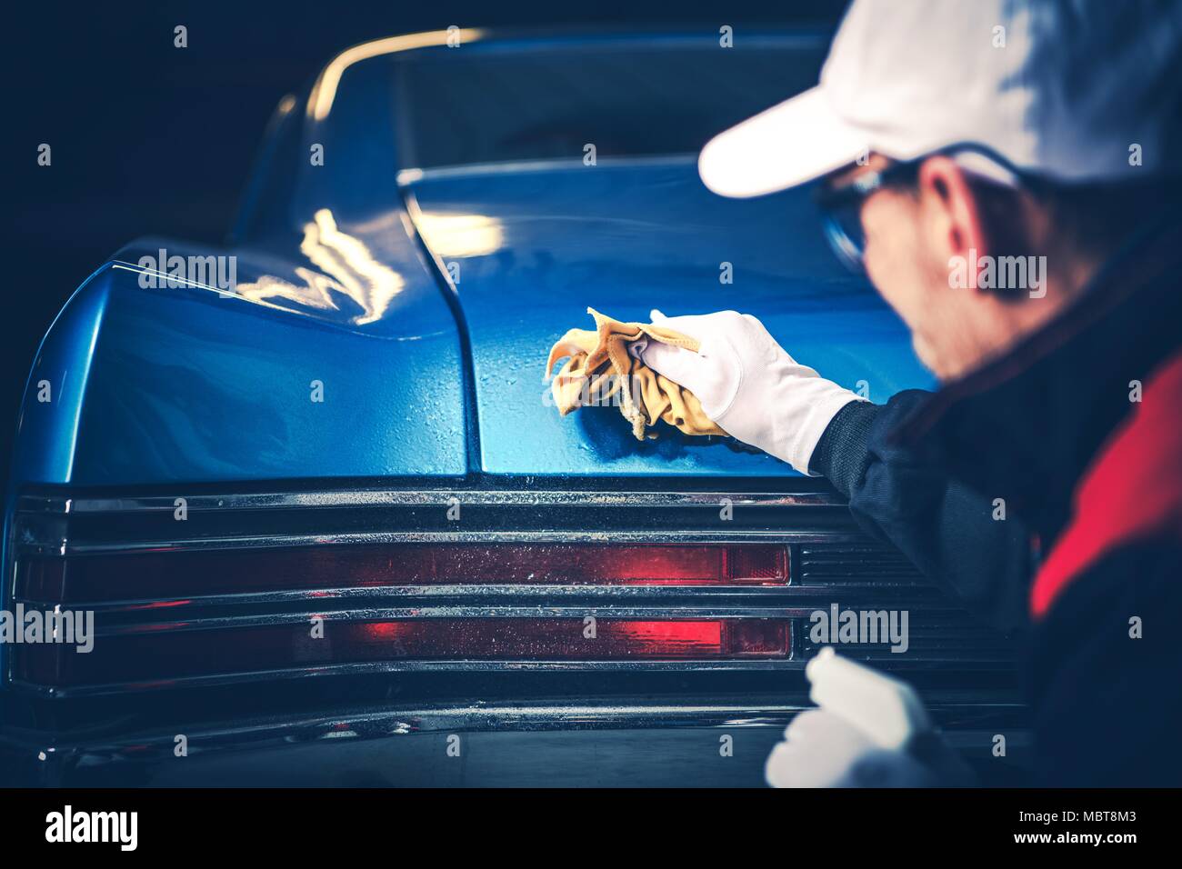 Vintage Classic Car Cleaning. Blue American Muscle Car Cleaned by His Passionate Owner. Stock Photo