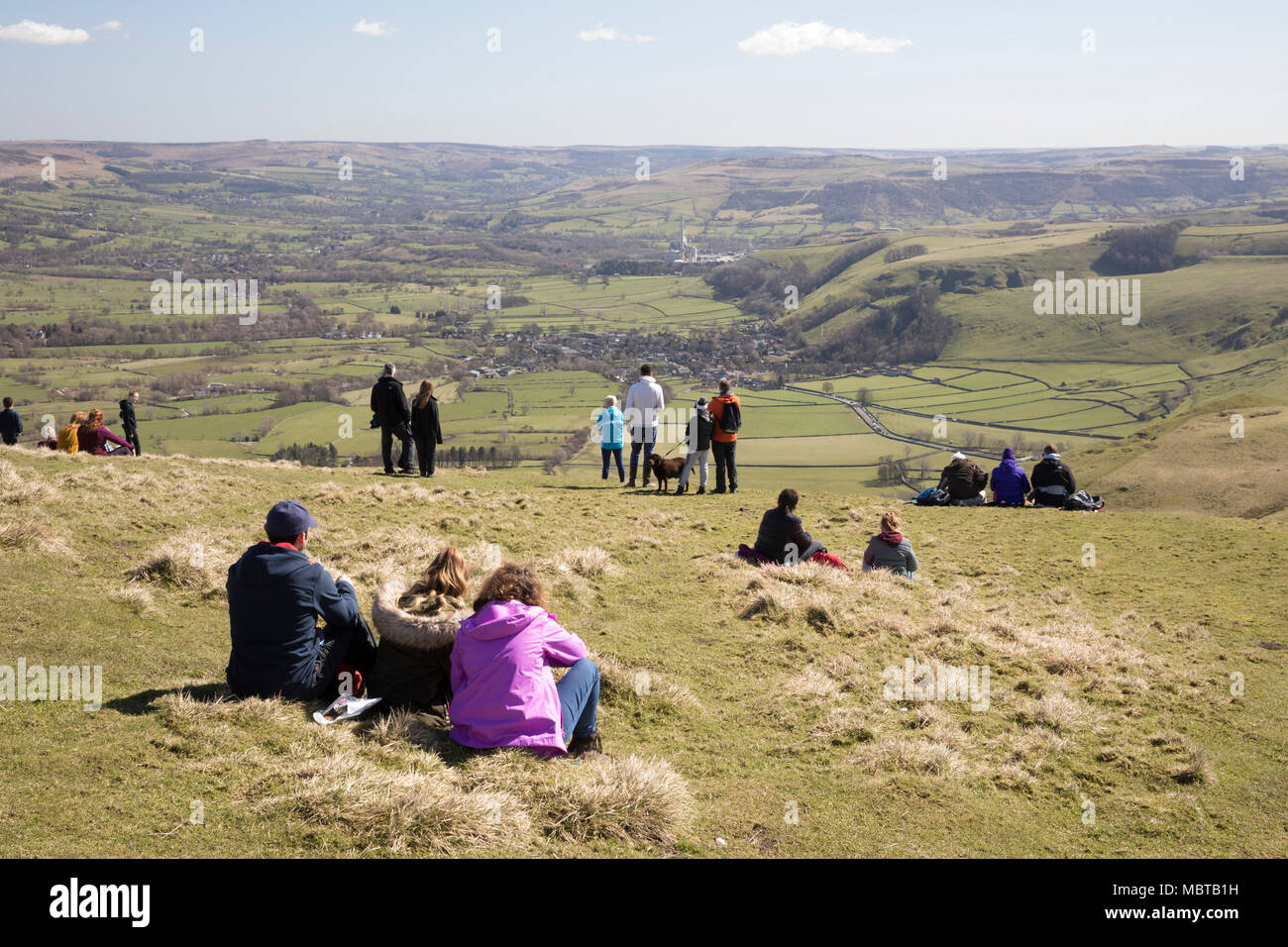 Families enjoying view over the Hope Valley and Castleton from summit of Mam Tor, Castleton, Peak District National Park, Derbyshire, England Stock Photo