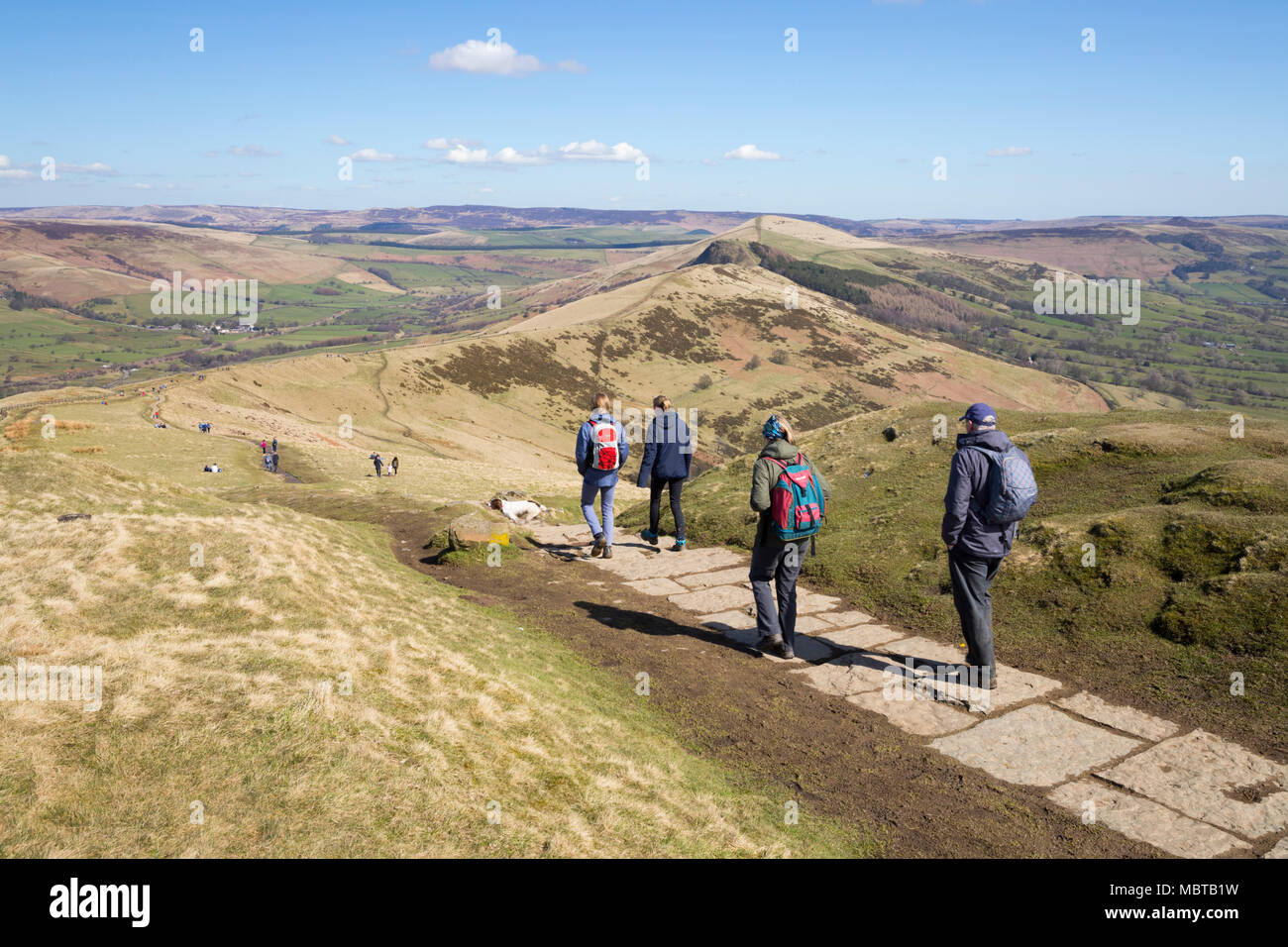 Walkers on the Great Ridge walk heading towards Lose Hill with views of the Edale and Hope valleys, Castleton, Peak District National Park Stock Photo