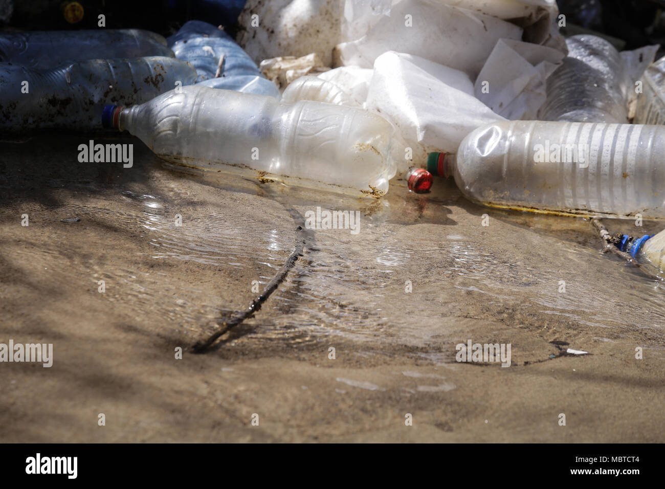 Heavy polluted water stream with domestic garbage Stock Photo - Alamy