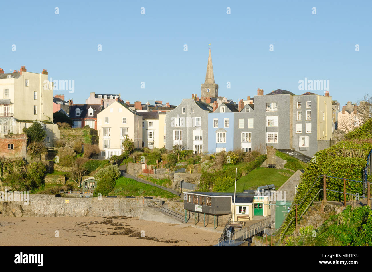 Colourful houses overlooking Castle Beach, Tenby in the early morning sunshine Stock Photo