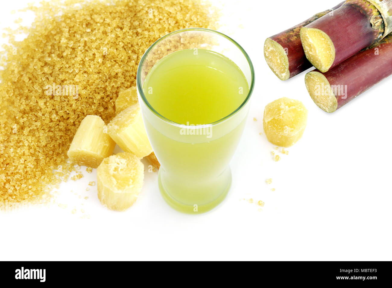sugar cane juice and fresh sugarcane cut, cane, granulated sugar yellow brown on white background Stock Photo