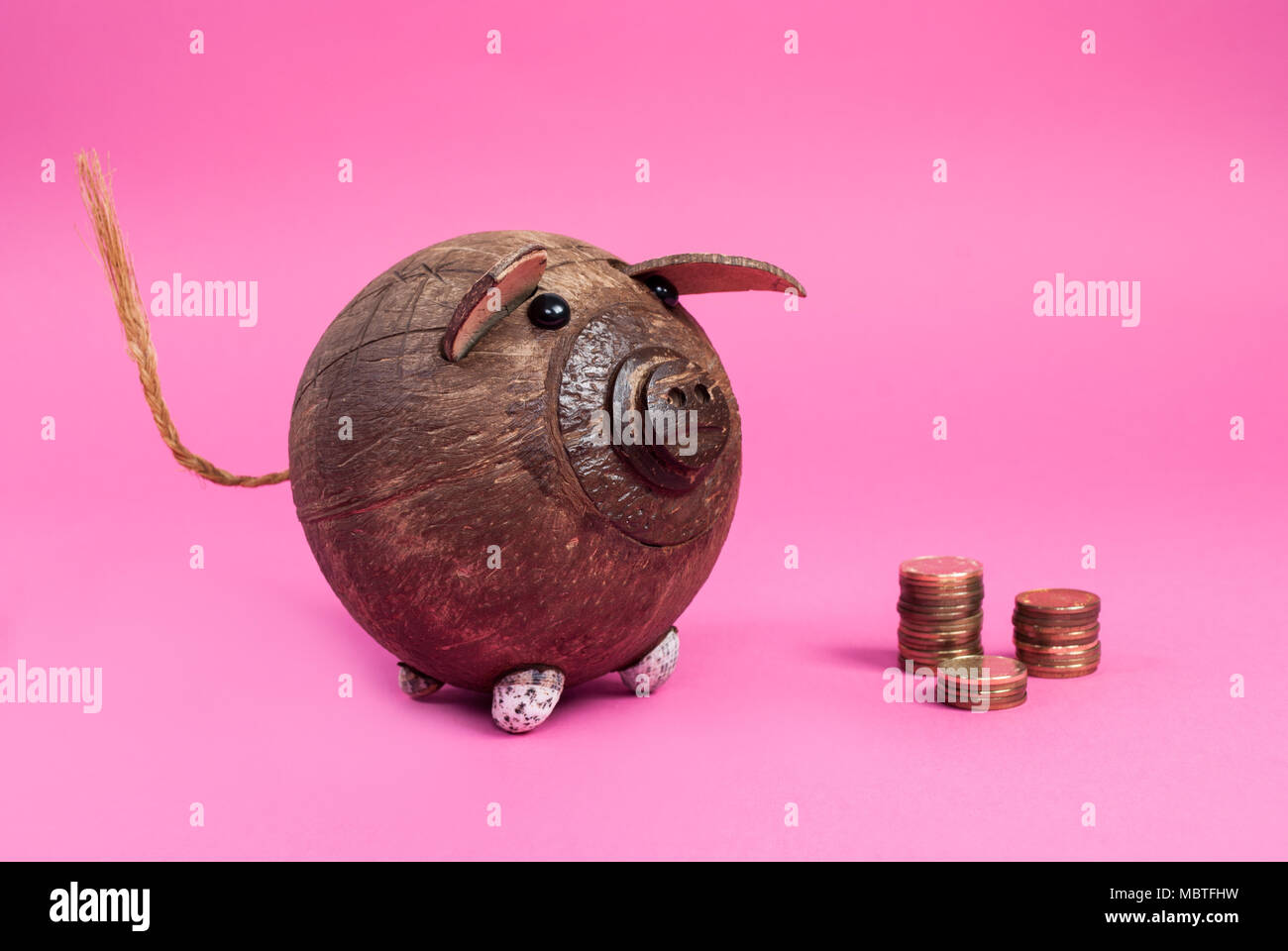 Cute piggy bank and coin isolated on pink background Stock Photo - Alamy