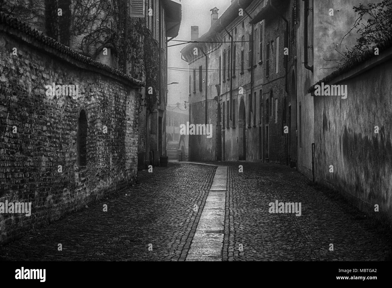 The mistic street in the city, foggy day in Italy Stock Photo